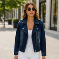 Dark wash cropped denim moto jacket worn with white jeans