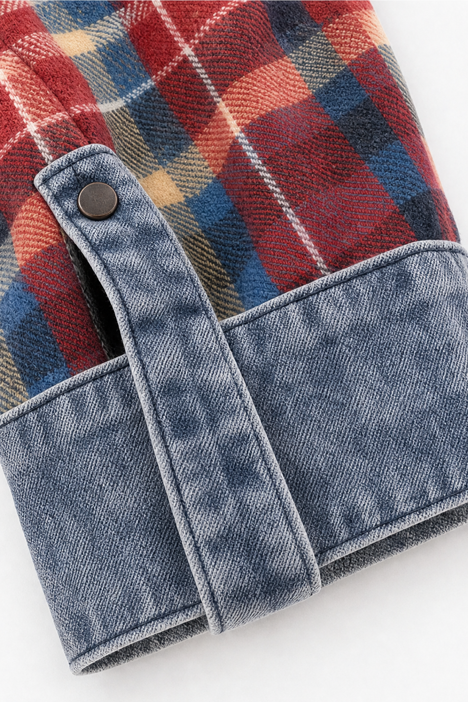 Denim trimmed patch pocket and cuff tab on a plaid cardigan