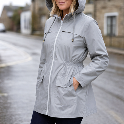 Grey hooded rain jacket with a cinched waist and patch pockets