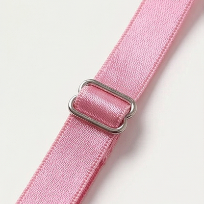 Silver slider on a pink satin shoulder strap