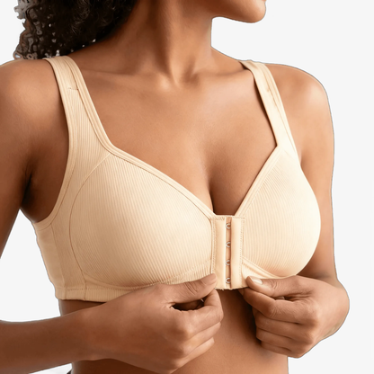 Hands fastening the front closure of a cream ribbed bra