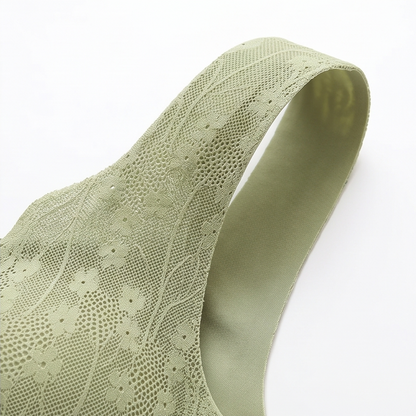 Wide sage lace shoulder strap laid on a white surface