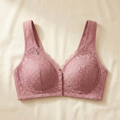 Dusty pink lace front-snap bra laid flat on linen