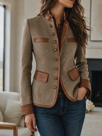 Taupe herringbone tweed jacket worn with jeans by a fireplace
