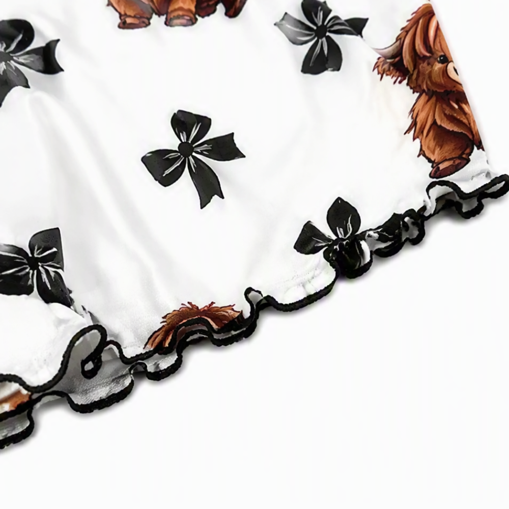 Close-up of the black ruffle trim on the printed shorts