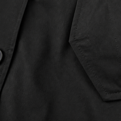 Set in sleeve seam on a black cotton hooded coat