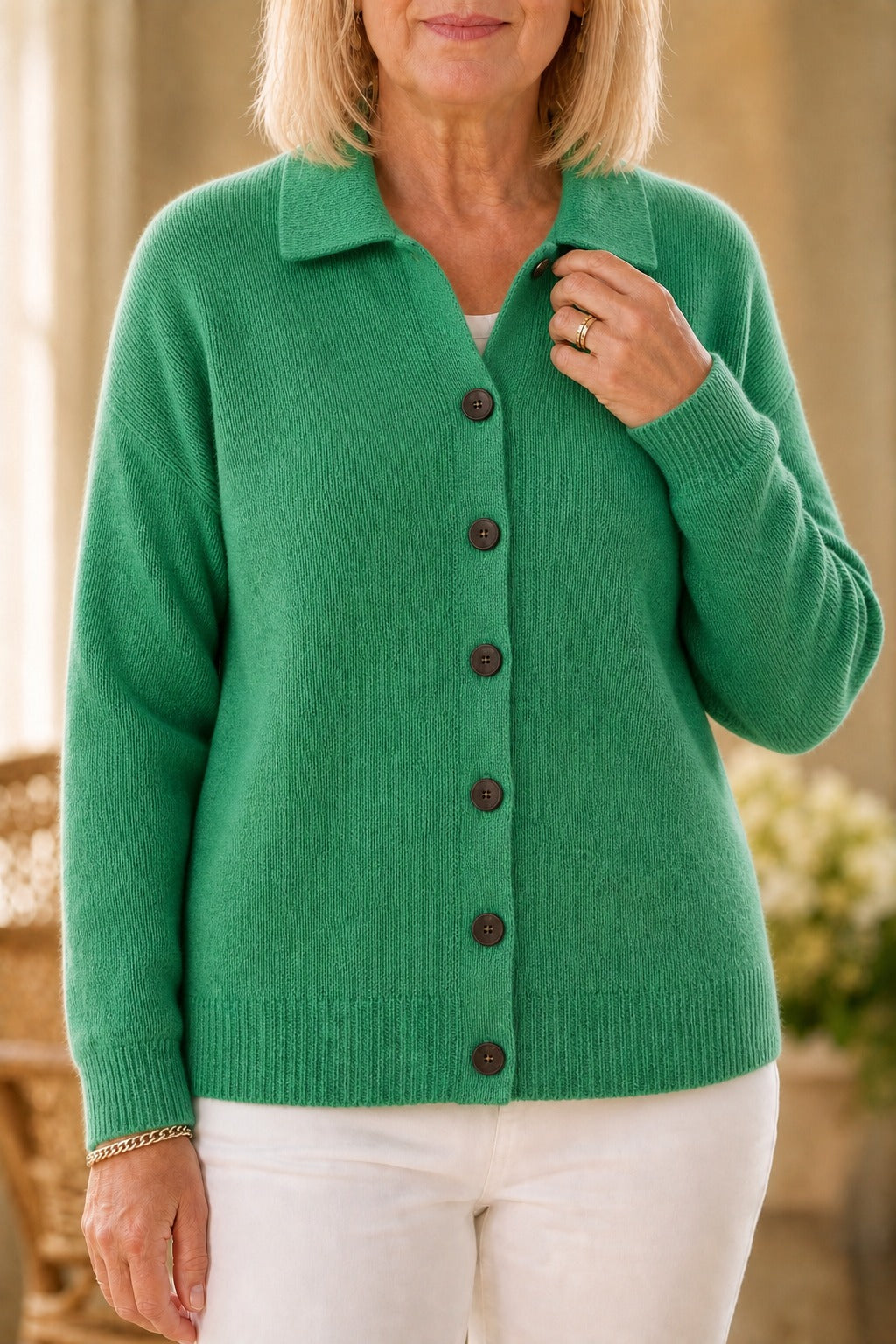 Green knit collared cardigan buttoned over a white top