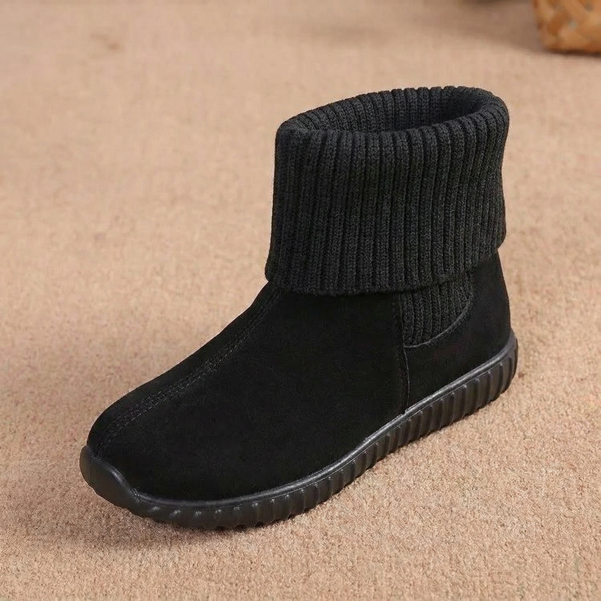 Black suede ankle bootie with a knit cuff, side view