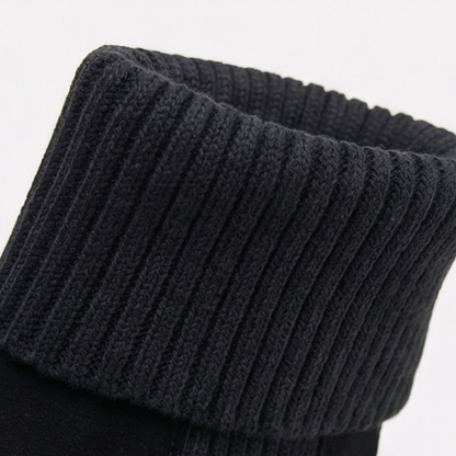 Close up of the folded ribbed knit cuff on a black bootie