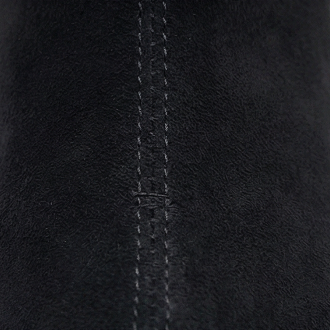 Close up of the stitched black suede upper