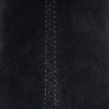 Close up of the stitched black suede upper
