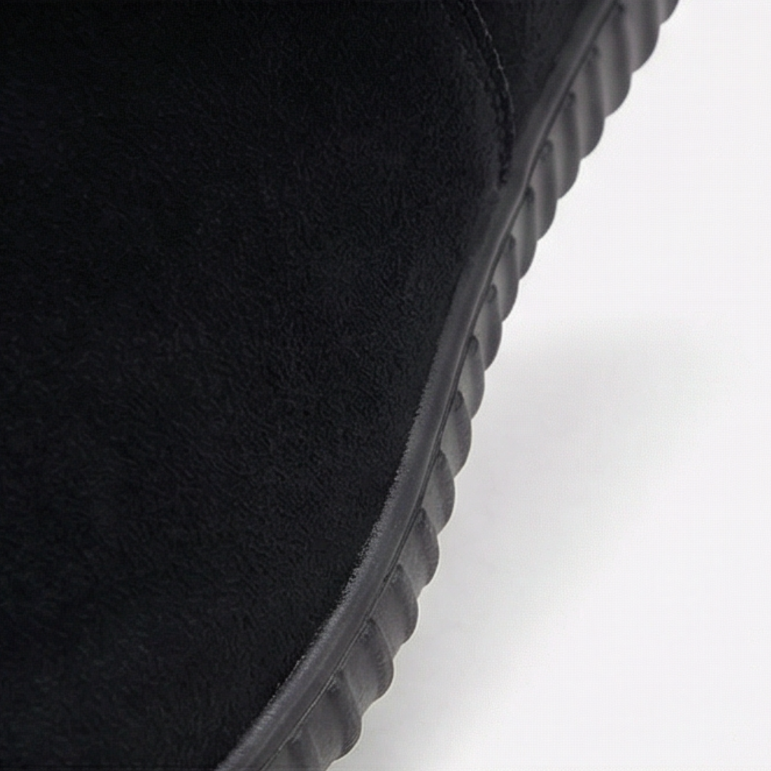 Close up of the flexible black sole on a suede bootie