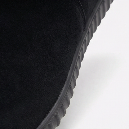 Close up of the flexible black sole on a suede bootie