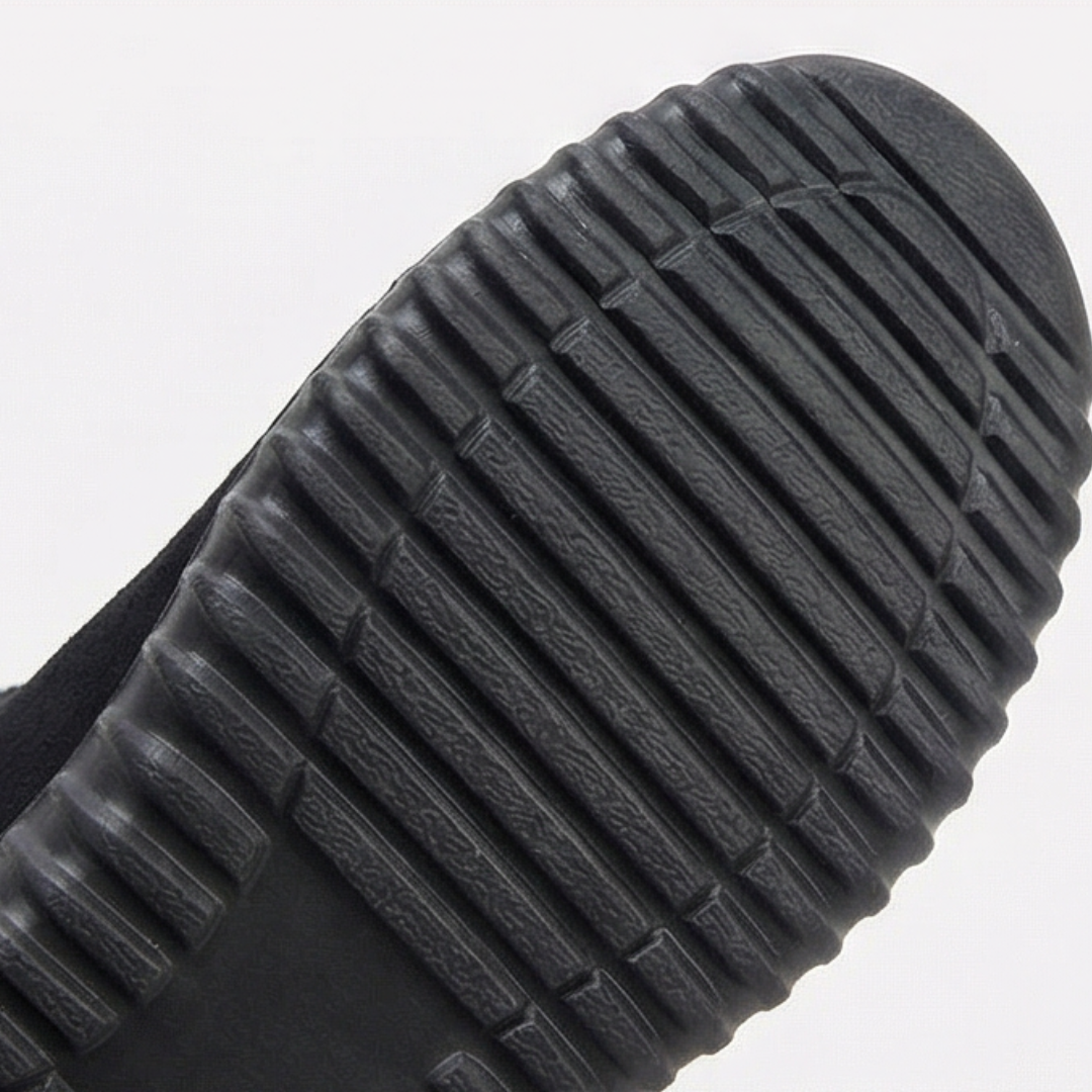 Treaded black outsole of a knit cuff suede bootie