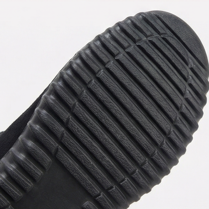 Treaded black outsole of a knit cuff suede bootie