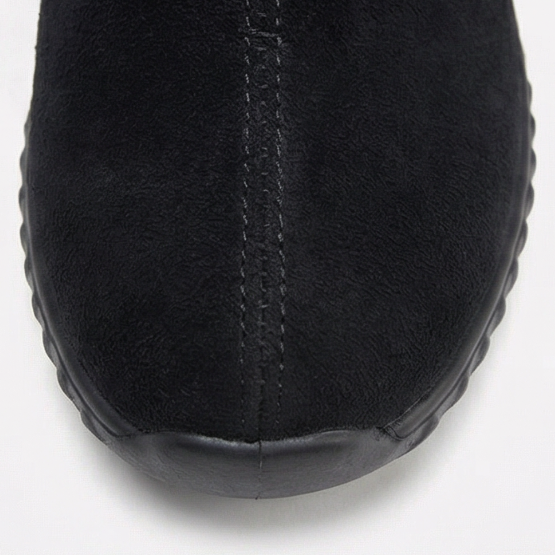 Rounded toe detail on a black suede ankle bootie