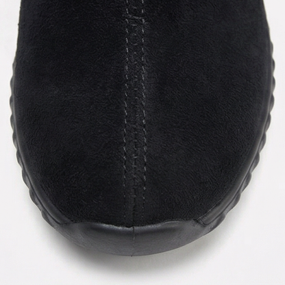 Rounded toe detail on a black suede ankle bootie