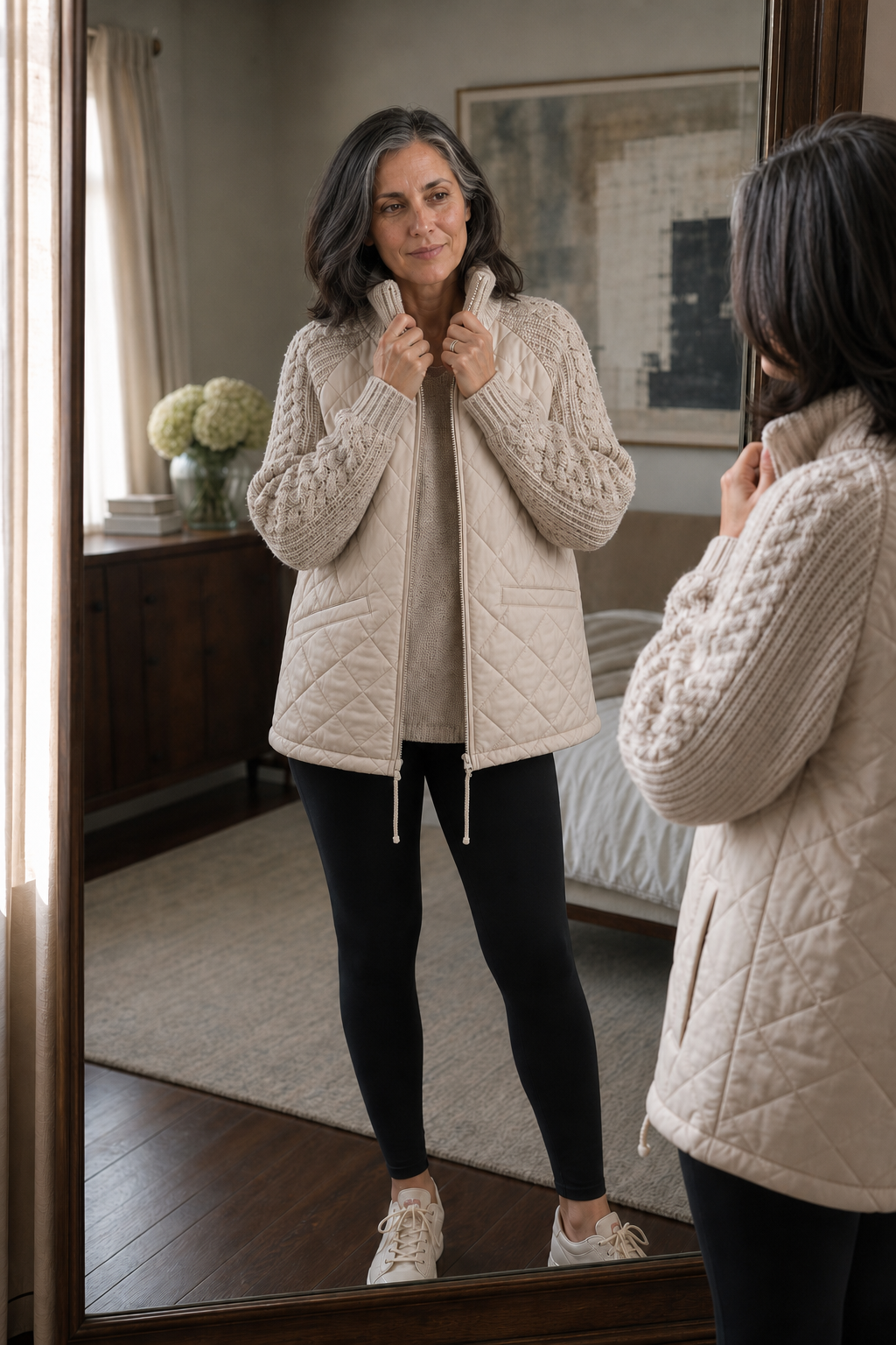 Cream quilted cable knit jacket seen in a mirror with black leggings