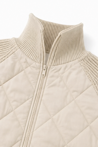 Close up of the ribbed collar and zip on a cream quilted jacket