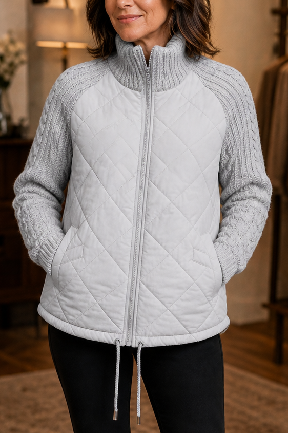 Light grey quilted jacket with cable knit sleeves and a drawcord hem