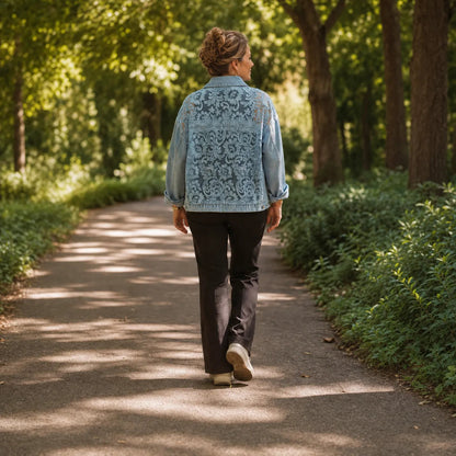 Woman walking a tree lined path in a lace patchwork denim jacket