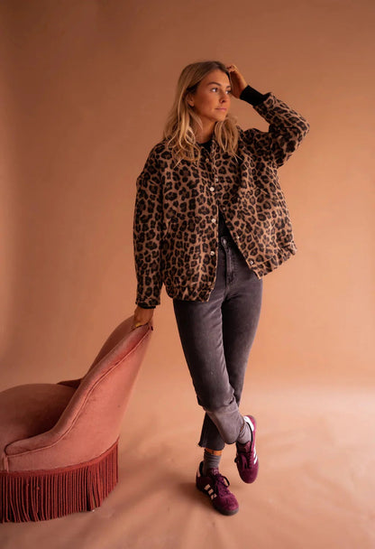 Leopard print bomber jacket worn open over a black top