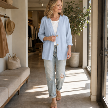 Light blue lightweight cardigan worn with ripped jeans in a shop