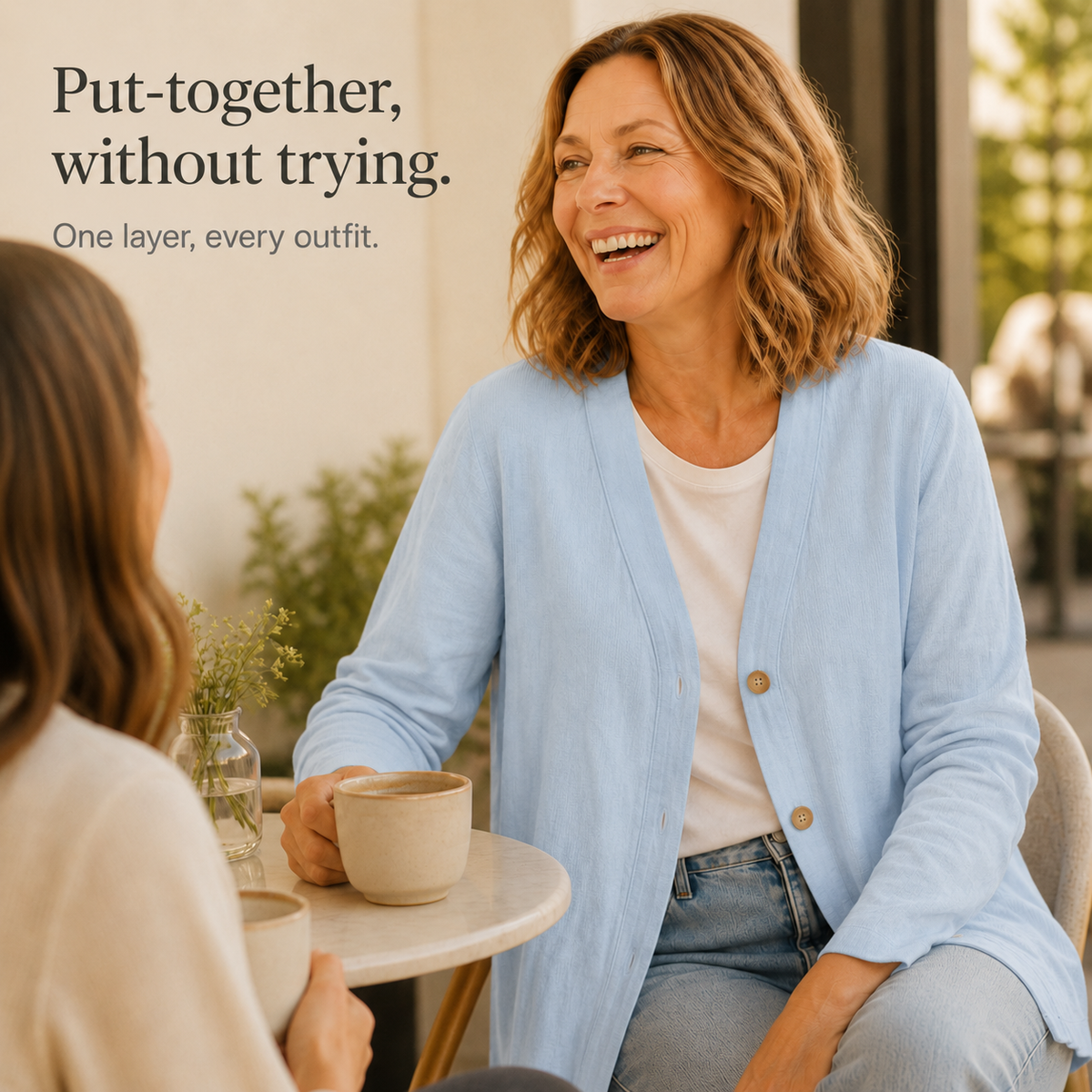 Feature panel of the light blue cardigan worn at a cafe table