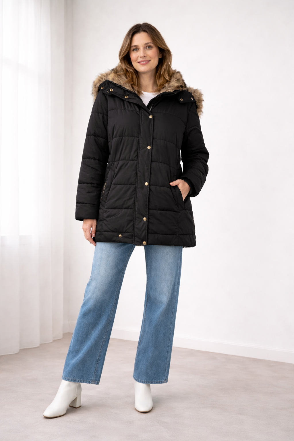 Black quilted snap-front jacket with a faux fur trimmed hood