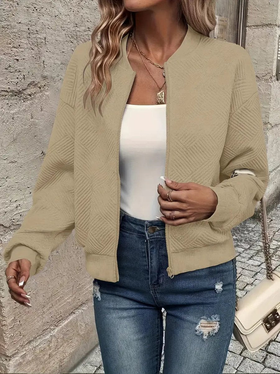 Khaki textured knit zip-up cropped bomber jacket worn over jeans
