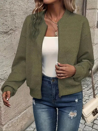 Olive textured knit zip-up cropped bomber jacket worn over jeans