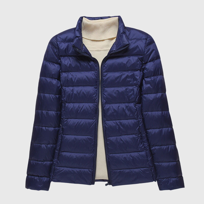 Navy quilted puffer jacket with a stand collar, flat lay