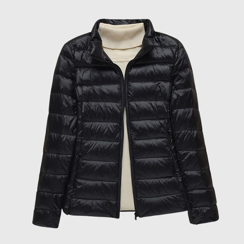 Black quilted puffer jacket with a stand collar, flat lay