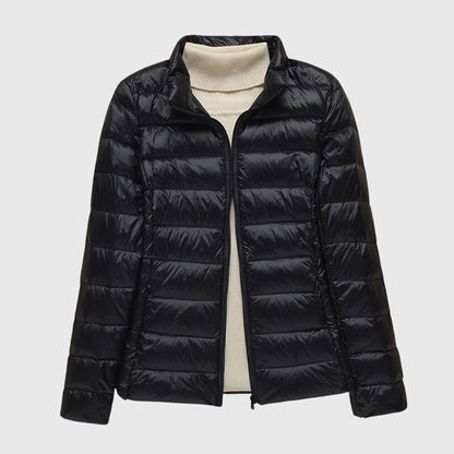 Black quilted puffer jacket with a stand collar, flat lay