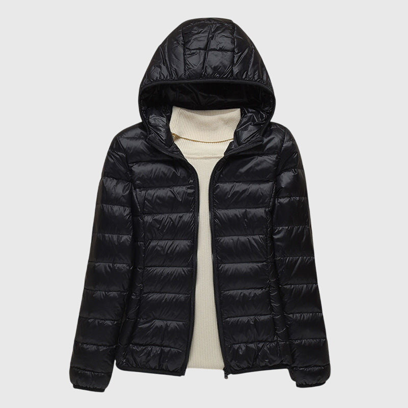 Black lightweight quilted puffer jacket with a hood, flat lay