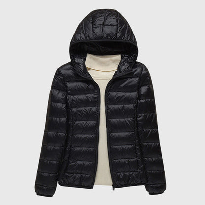 Black lightweight quilted puffer jacket with a hood, flat lay