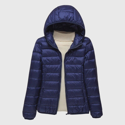 Navy lightweight quilted puffer jacket with a hood, flat lay