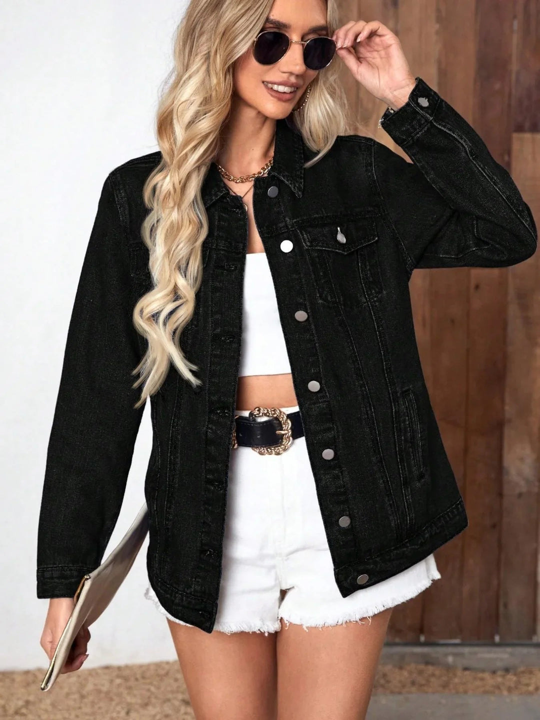 Black relaxed button-front denim jacket worn with white shorts