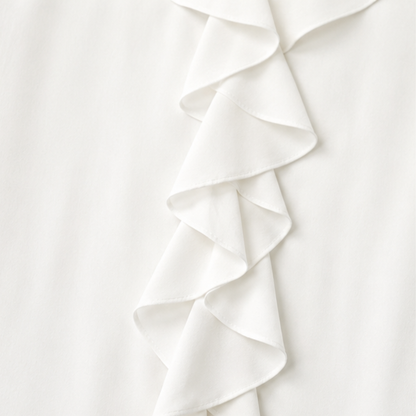 Close up of the cascading ruffle placket on a white blouse
