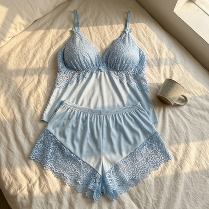 Blue satin cami and shorts laid flat on a bed