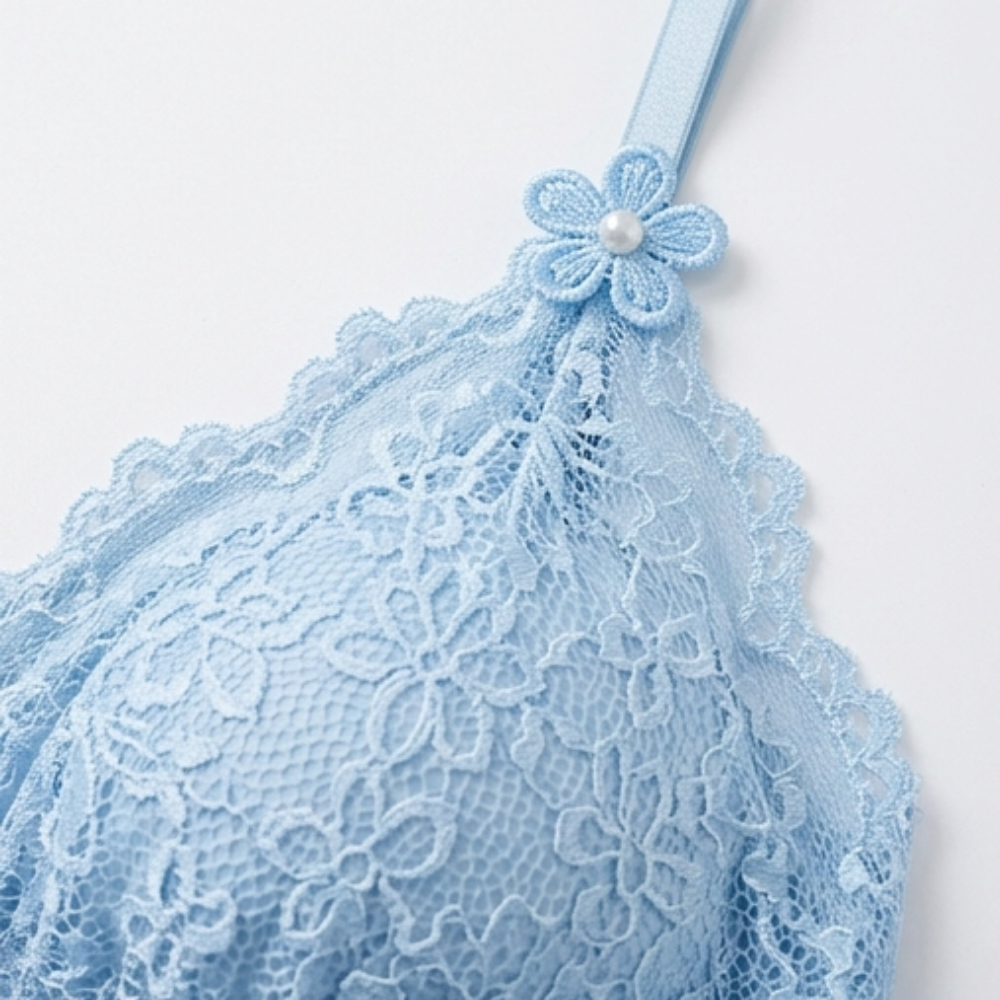 Close-up of the floral lace cup on a blue satin cami