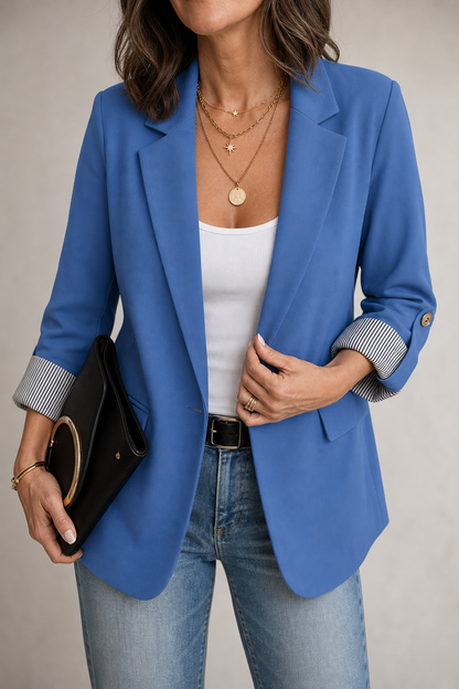 Blue striped cuff blazer worn with jeans and a clutch bag