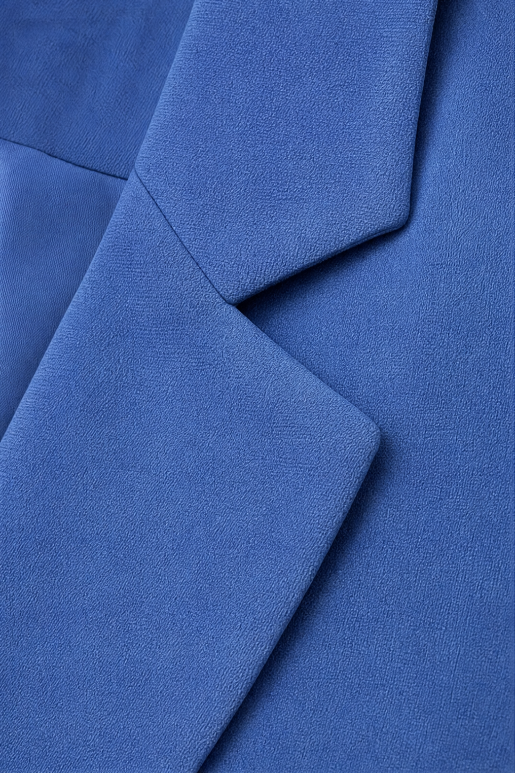 Notch lapel and shoulder seam on a blue blazer