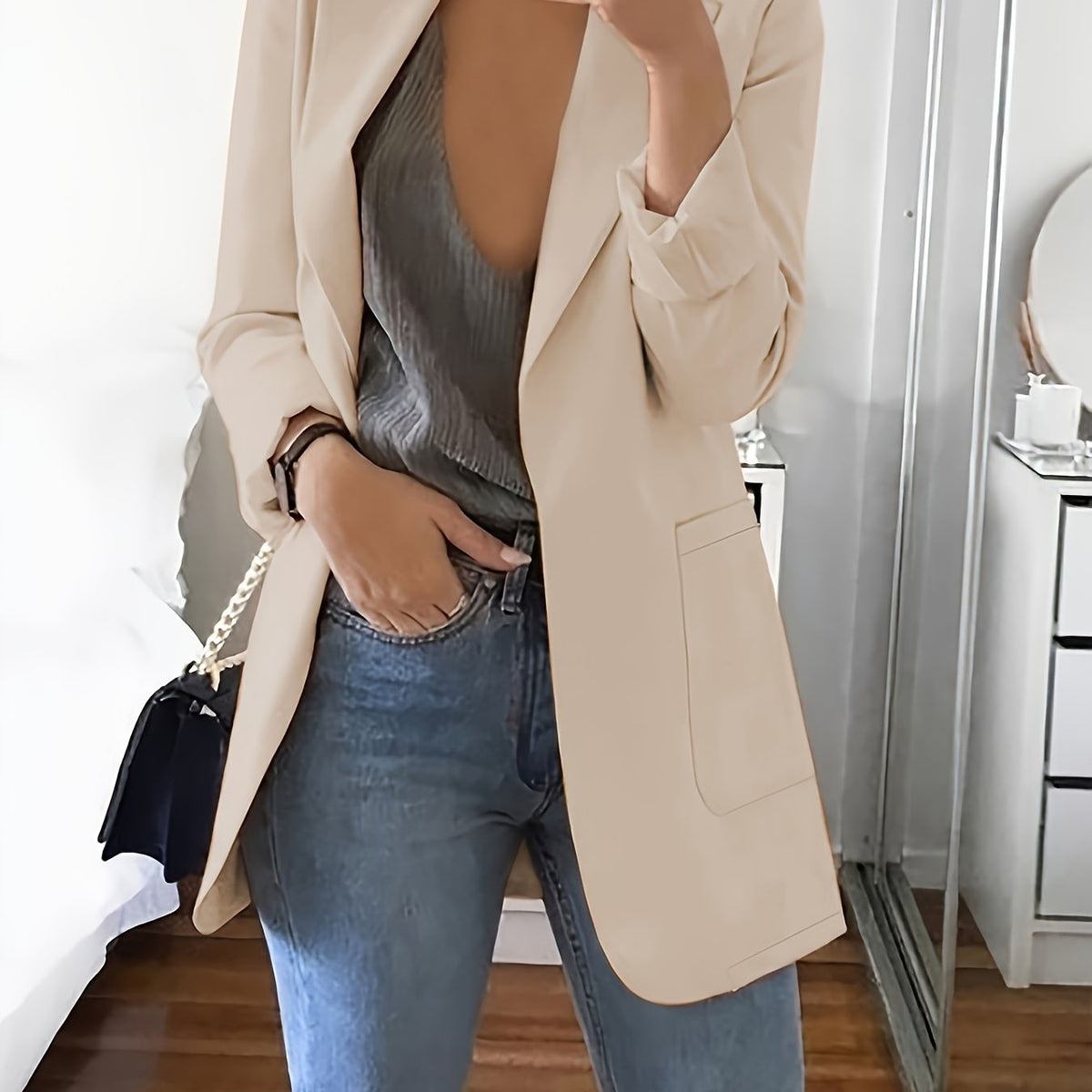 Beige tailored longline blazer worn open over jeans