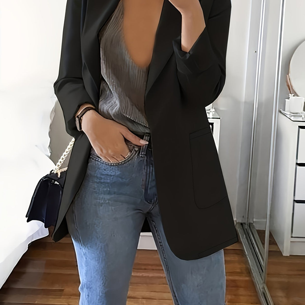 Black tailored longline blazer worn open over jeans
