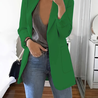 Green tailored longline blazer worn open over jeans