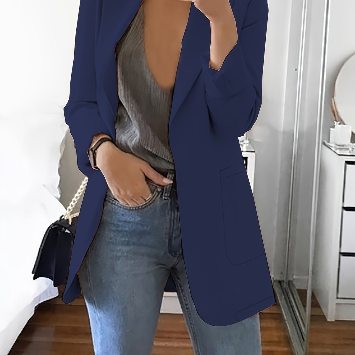 Navy tailored longline blazer worn open over jeans
