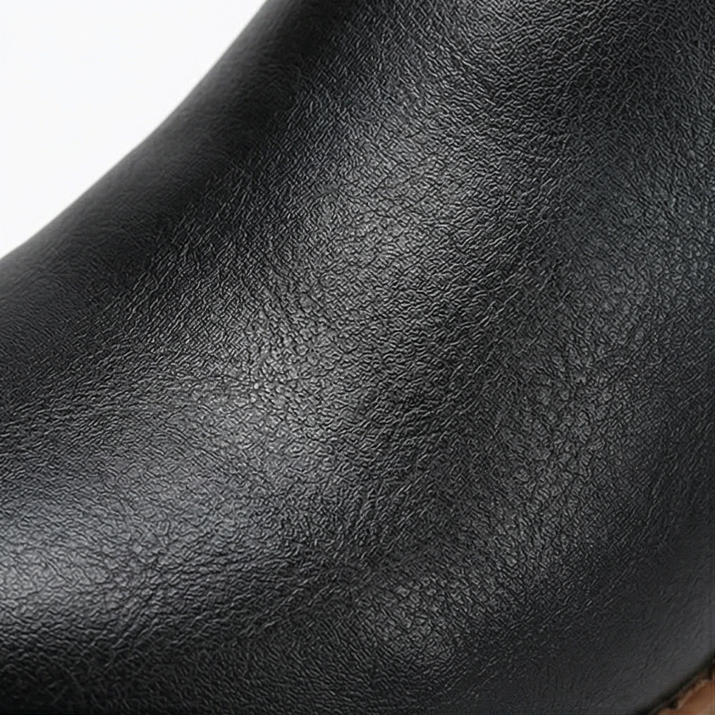 Close up of the soft pebbled black upper on a lace up boot