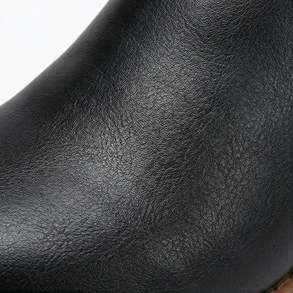 Close up of the soft pebbled black upper on a lace up boot