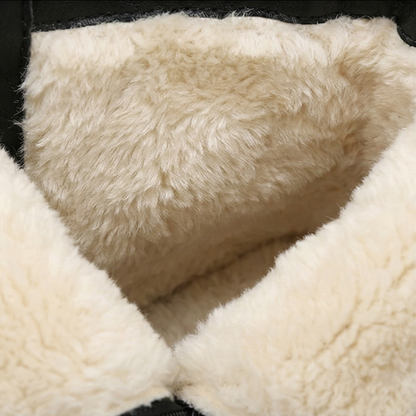 Close-up of the thick cream wool lining inside a black lace up boot